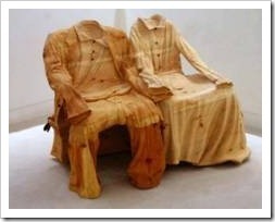 A couple sculpted in wood